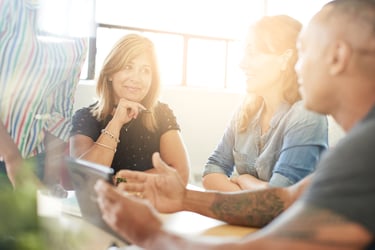 Unposed group of creative business people in an open concept office brainstorming their next project.-4